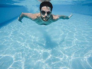 a man swimming in the heated pool