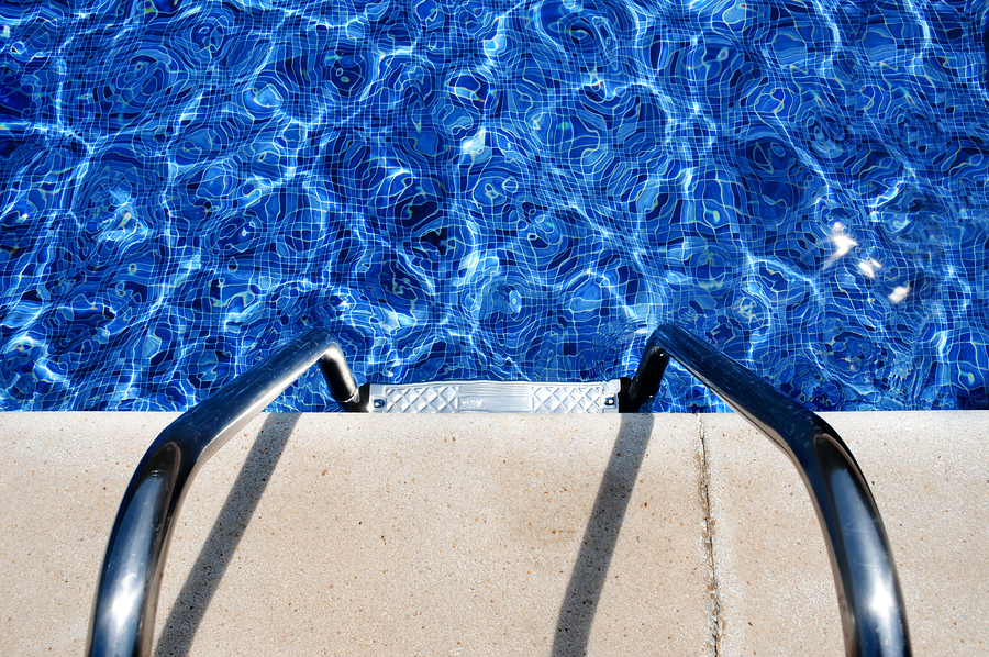 a pool that is installed with white marble plaster